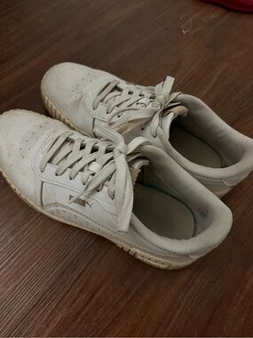 Heavily worn woman’s Puma Tennis Shoes